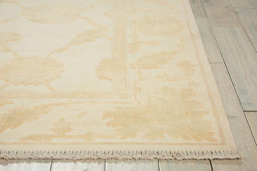 Close up of the Nourison Silk Pointe Ivory Vintage Rug showing chestnut floral pattern and fringe.