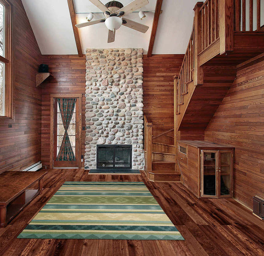 Rustic living room with wood walls and Nourison India House Blue Green Persian Rug.