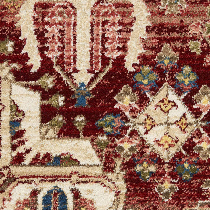 Close-up of the Nourison Karisma Brick Ivory rug, featuring a detailed farmhouse pattern in chestnut, ivory, blue, and green tones.