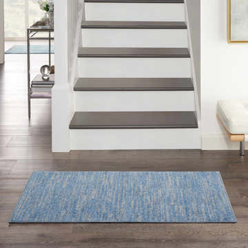 Entryway scene with Nourison Essentials Blue Grey Outdoor Area Rug runner on hardwood floor.