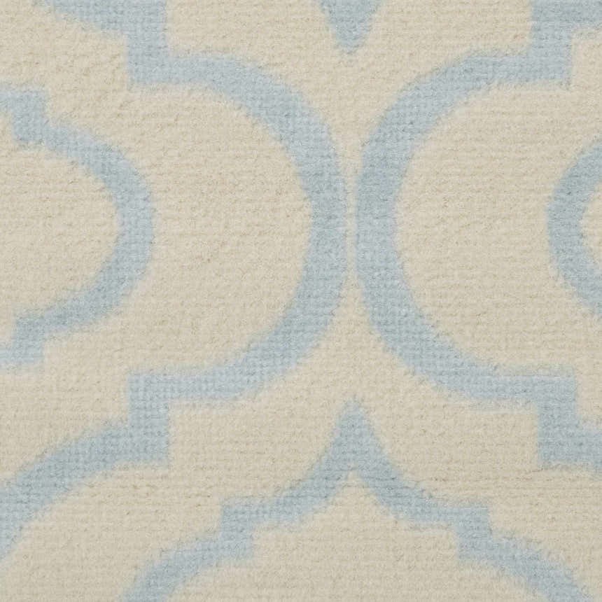 Close-up of the Nourison Jubilant Ivory Blue Rug, featuring a geometric trellis pattern and soft texture.