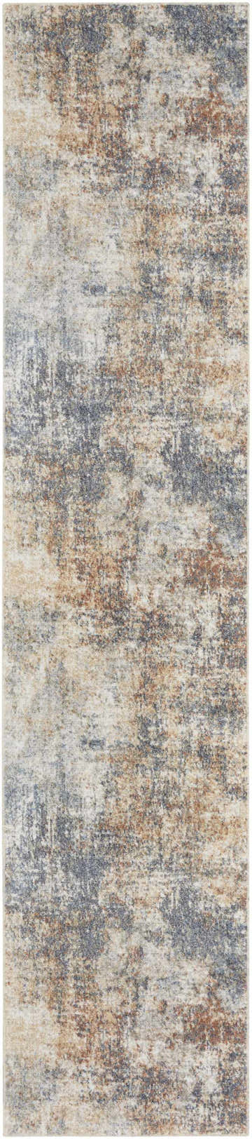 Close-up of the Nourison Astra Multicolor rug, featuring a distressed abstract pattern in blue, beige, and brown tones.
