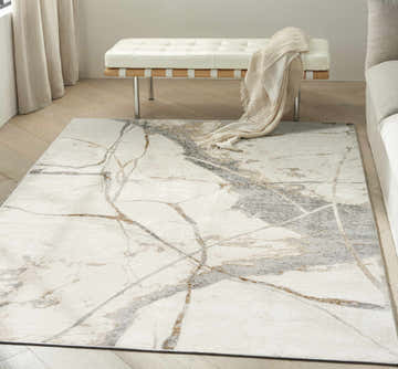 Modern living room with a Calvin Klein CK073 Compass rug, white bench, and neutral tones.