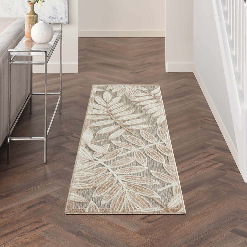 Hallway with Nourison Aloha Natural Tropical Area Rug runner, leaf pattern, wood floors, console table.