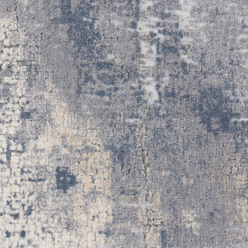 Close-up of the Nourison Rustic Textures Grey Beige rug showing its distressed, modern pattern and soft, textured pile.