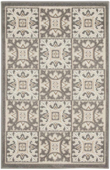 Close-up of the Nourison Aloha Ivory Grey rug featuring a contemporary tile-like pattern in ivory, grey, and chestnut.