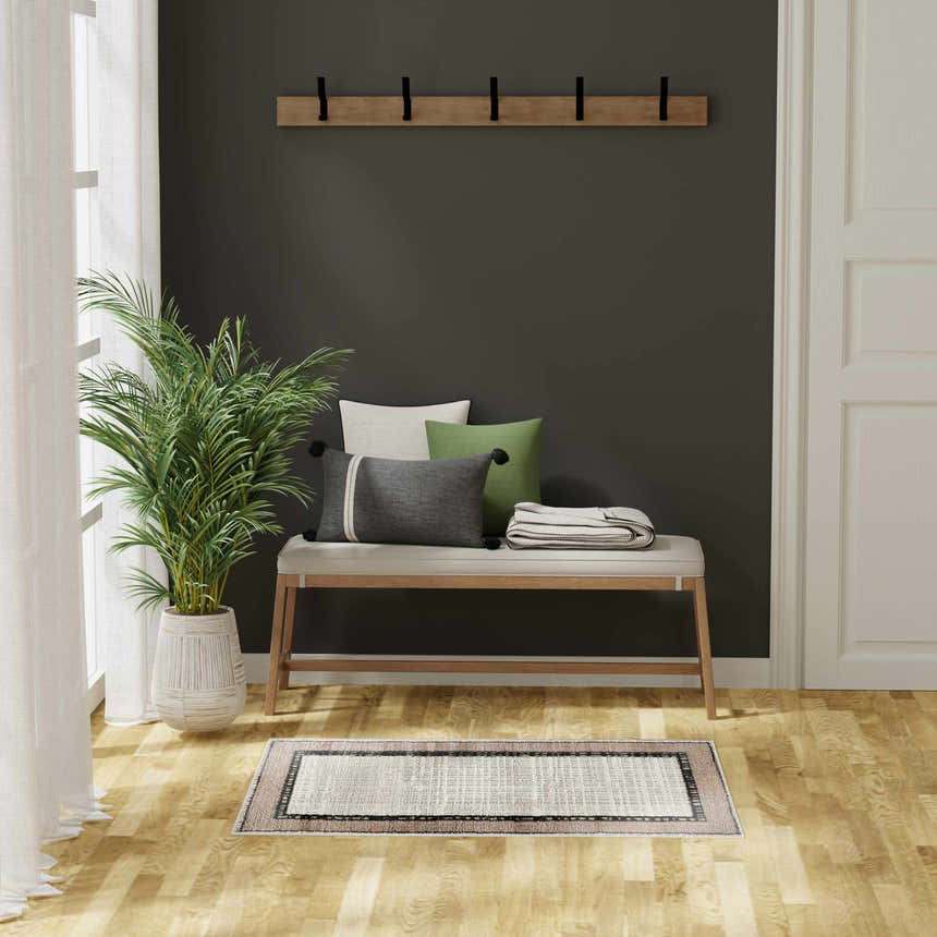 Entryway with bench, plant, and Nourison Dekor Grey Charcoal Modern Indoor Area Rug on wood floor.