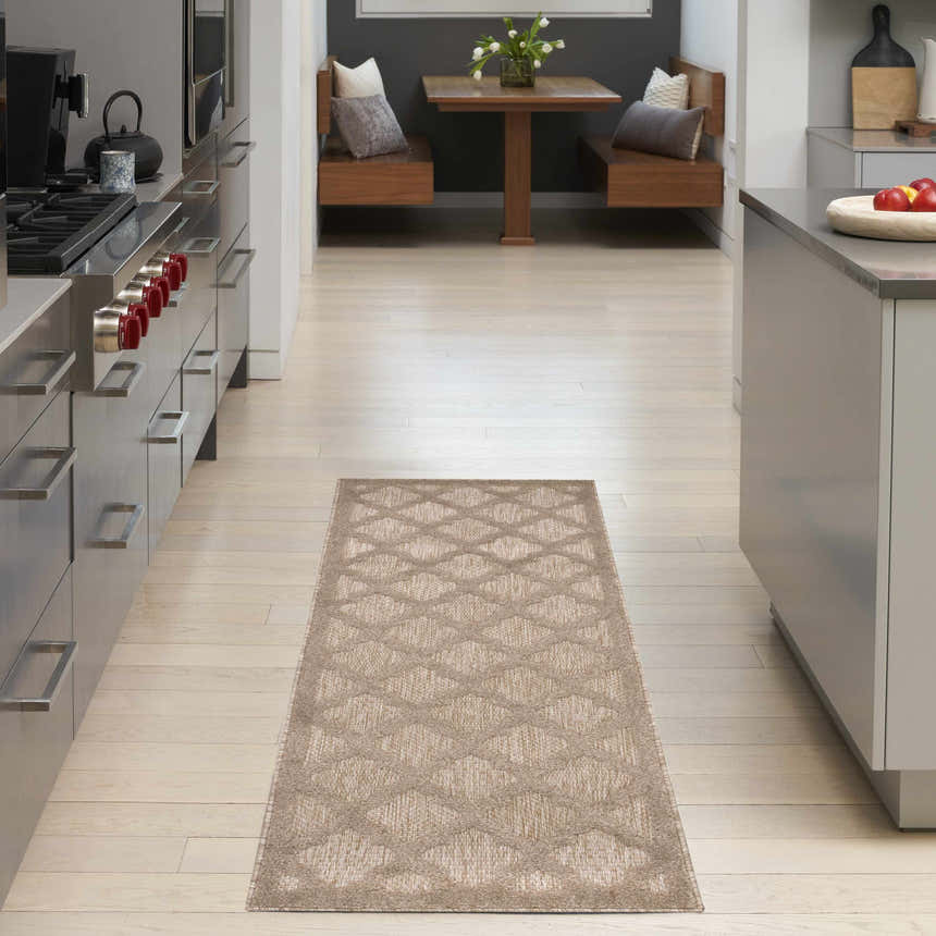 Modern kitchen scene with a Nourison Easy Care Natural Beige runner rug on light wood floors.