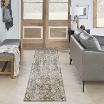 Entryway with gray bench, leather sofa, and Nourison Astra Gold Grey Vintage Indoor Washable Area Rug runner.
