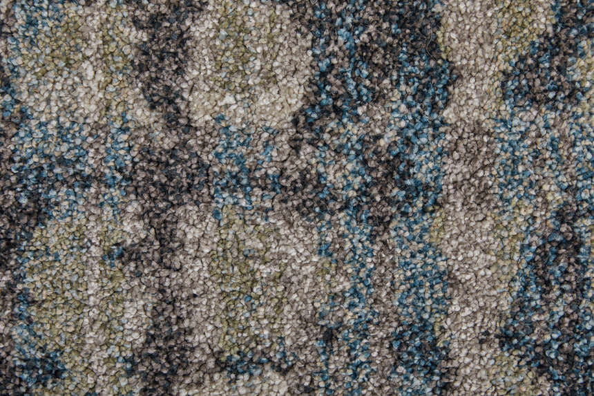 Close-up of the Feizy Skyview rug. Abstract design in gray, black, ivory, and blue tones. Soft, textured pile. Texture