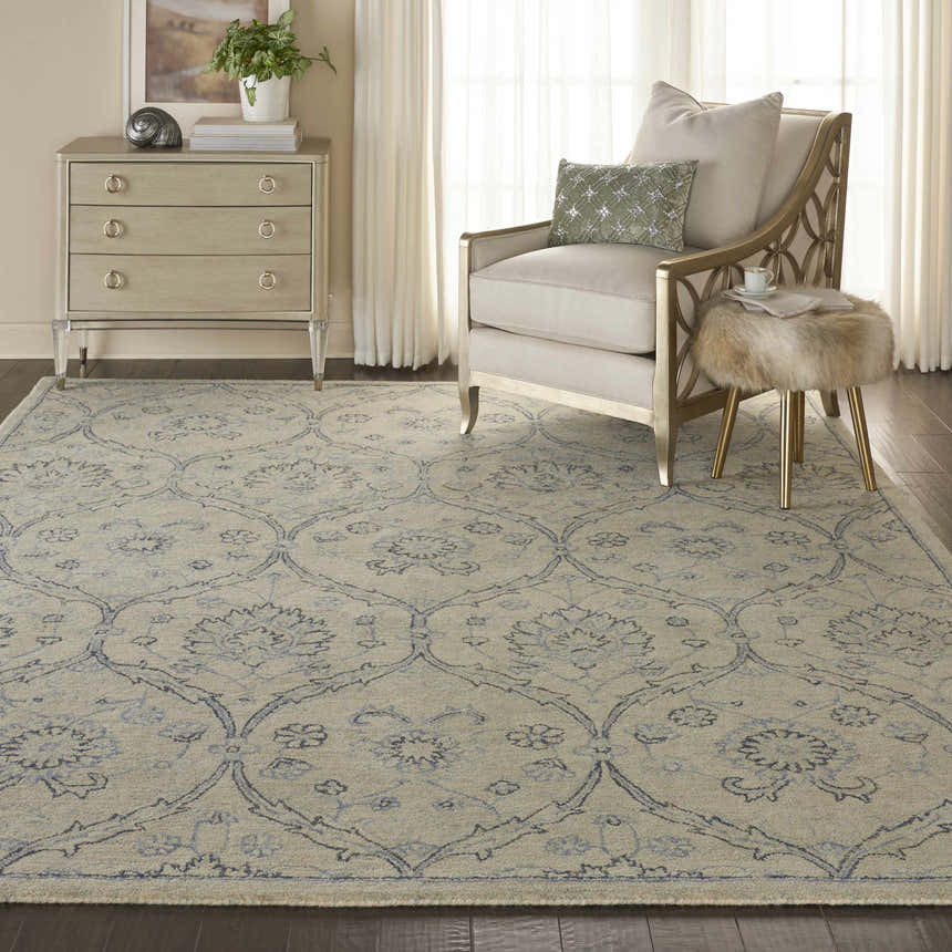 Living room scene with Nourison Jazmine Ivory/Blue Persian rug, neutral furniture, and a light, airy ambiance.