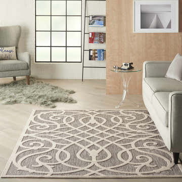 Farmhouse living room with gray sofa and Nourison Cozumel Grey Farmhouse Area Rug featuring a geometric trellis pattern.