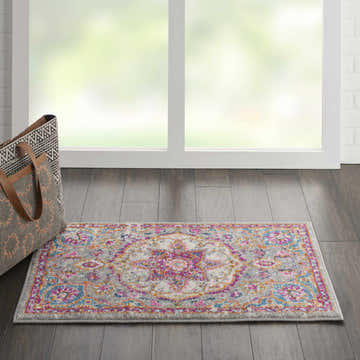 Bright room scene with Nourison Passion Grey Multicolor rug, wood floors, and patterned tote bag.