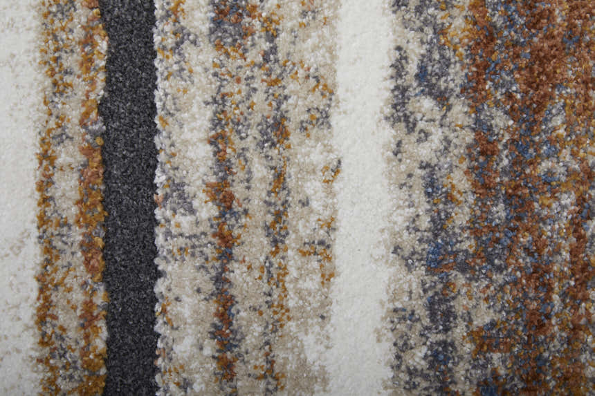 Close up of the Feizy Gilmore rug showing ivory, orange, and gray stripes and textured polypropylene fibers. Texture