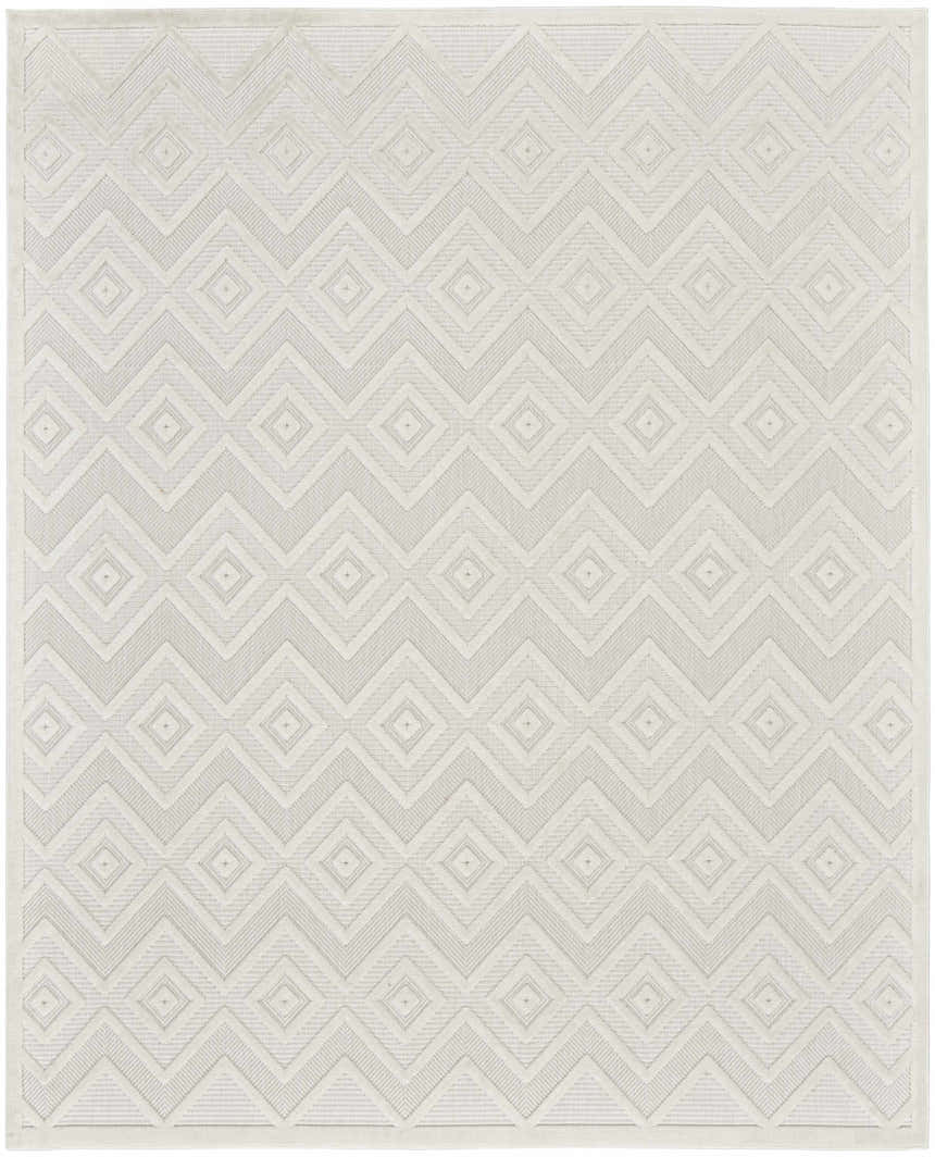Close-up of the Nourison Versatile Ivory White rug. Features a modern geometric diamond and chevron pattern. Neutral texture.