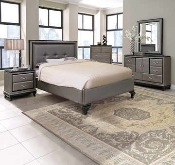Bedroom scene with taupe Michael Amini Platine Slate vintage rug, gray furniture, and city view.