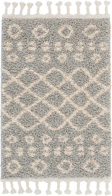 Close-up of the Nourison Moroccan Shag Silver Tribal Area Rug, featuring a gray and ivory geometric pattern and fringe.
