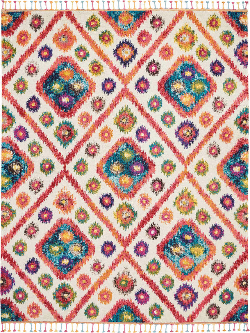 Close-up of Nourison Nomad Ivory Pink Tribal rug. Diamond and floral pattern with pink, blue, orange, and ivory hues. Tasseled edges.
