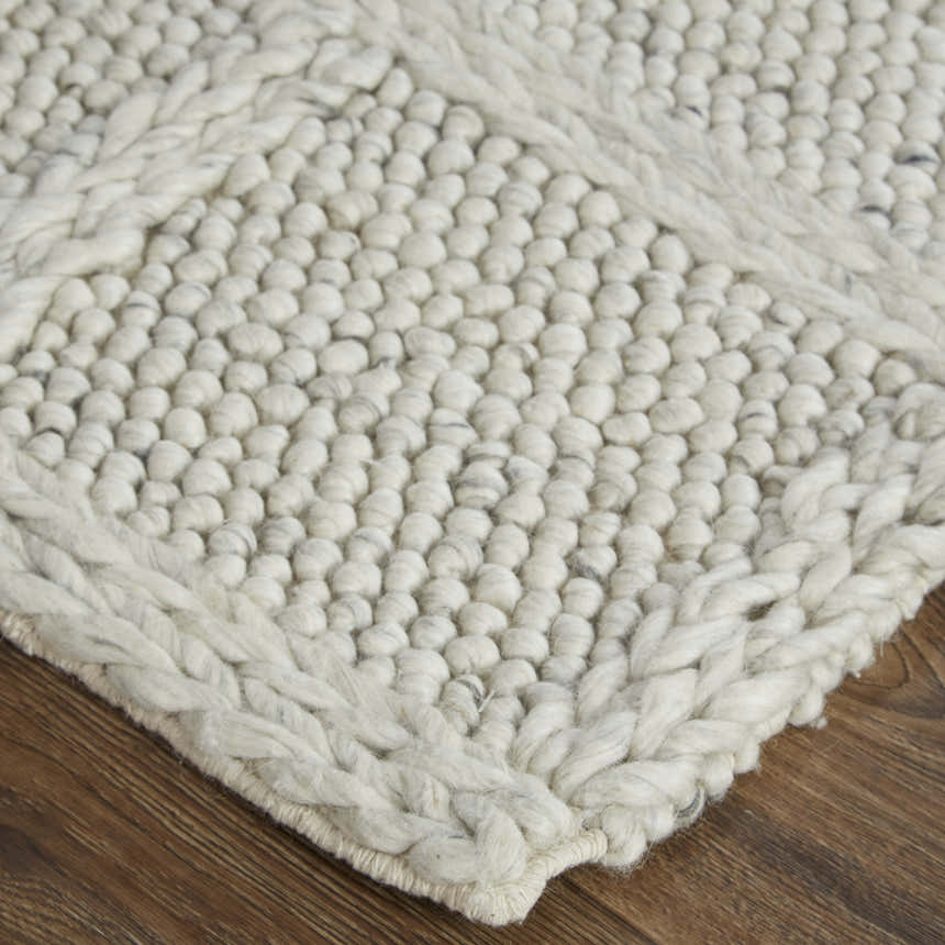 Close-up of Feizy Berkeley rug showing the ivory and gray wool, interlocking checkered texture, and hand woven construction. Corner