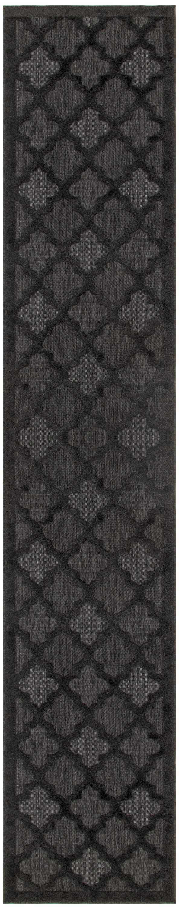 Close-up of the Nourison Easy Care Charcoal Black rug featuring a geometric diamond and quatrefoil pattern.