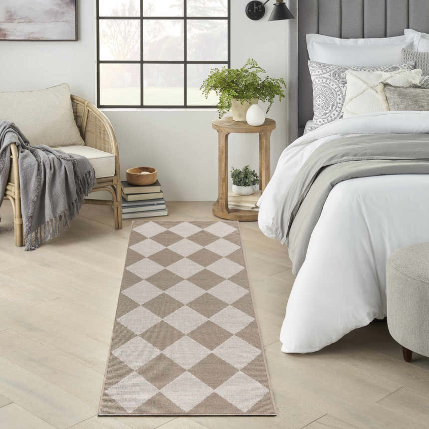 Bedroom scene with Nourison Modern Jute Natural Ivory rug. Chestnut diamond pattern on light wood floors, neutral decor.