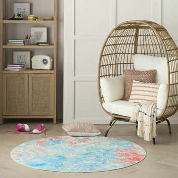 Kids room with a rattan chair and round Nourison Imagination Multicolor area rug.