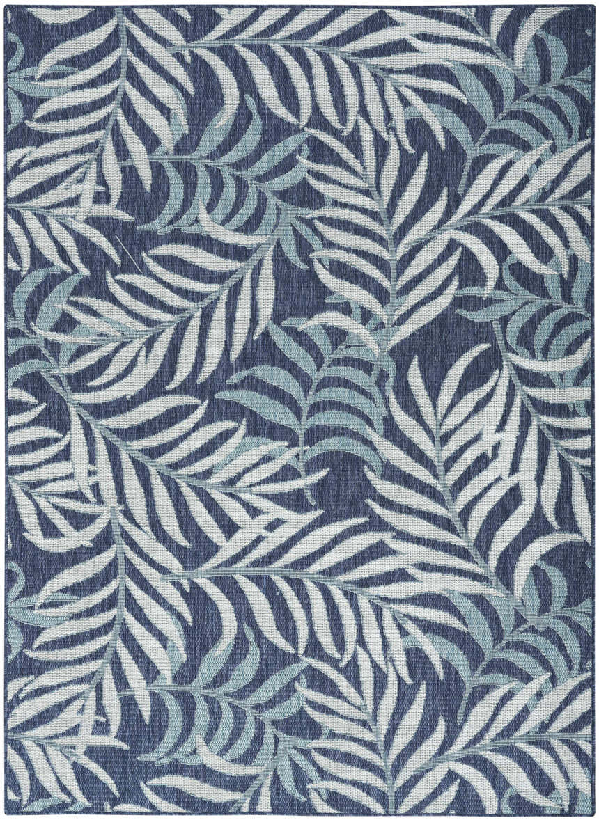 Close-up of Nourison Garden Oasis Navy Tropical Area Rug featuring a white and light blue leaf pattern on a navy background.