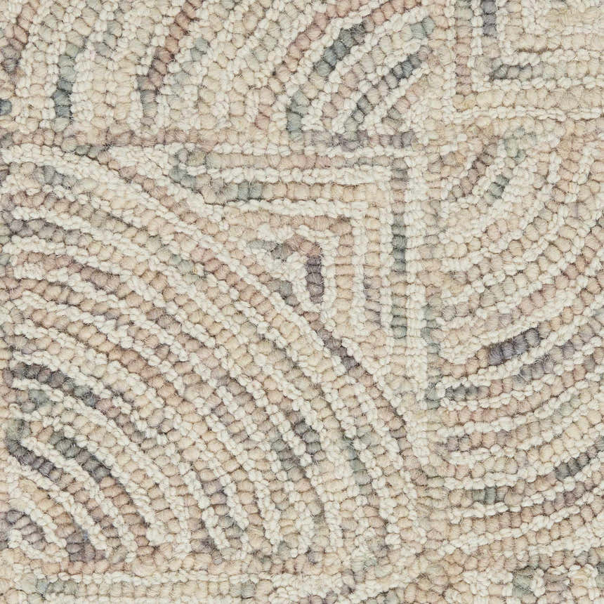 Close-up of the handmade Nourison Interlock Ivory Multicolor rug, showing texture and mid-century modern pattern.