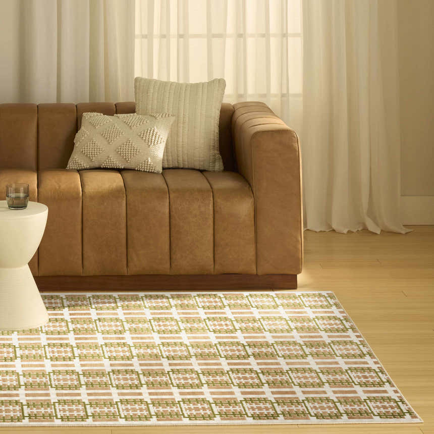 Living room scene with a brown leather sofa and Nourison Nordic Multicolor Area Rug.