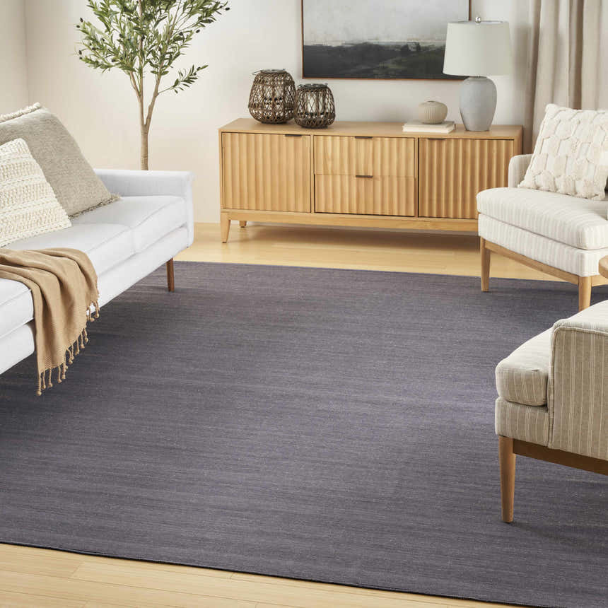 Living room with white sofa and Nourison Essentials Navy Modern Area Rug.