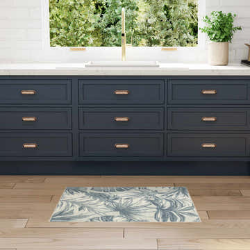 Modern kitchen with blue cabinets and Nourison Aloha Ivory Blue Area Rug.