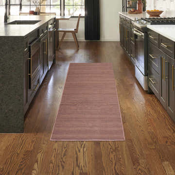 Modern kitchen with Nourison Essentials Mocha runner rug on hardwood floors.