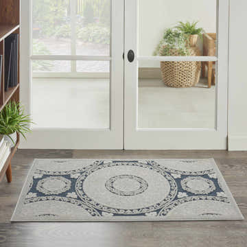 Entryway with Nourison Key Largo Blue Contemporary Area Rug runner, light blue medallion pattern on wood floor.