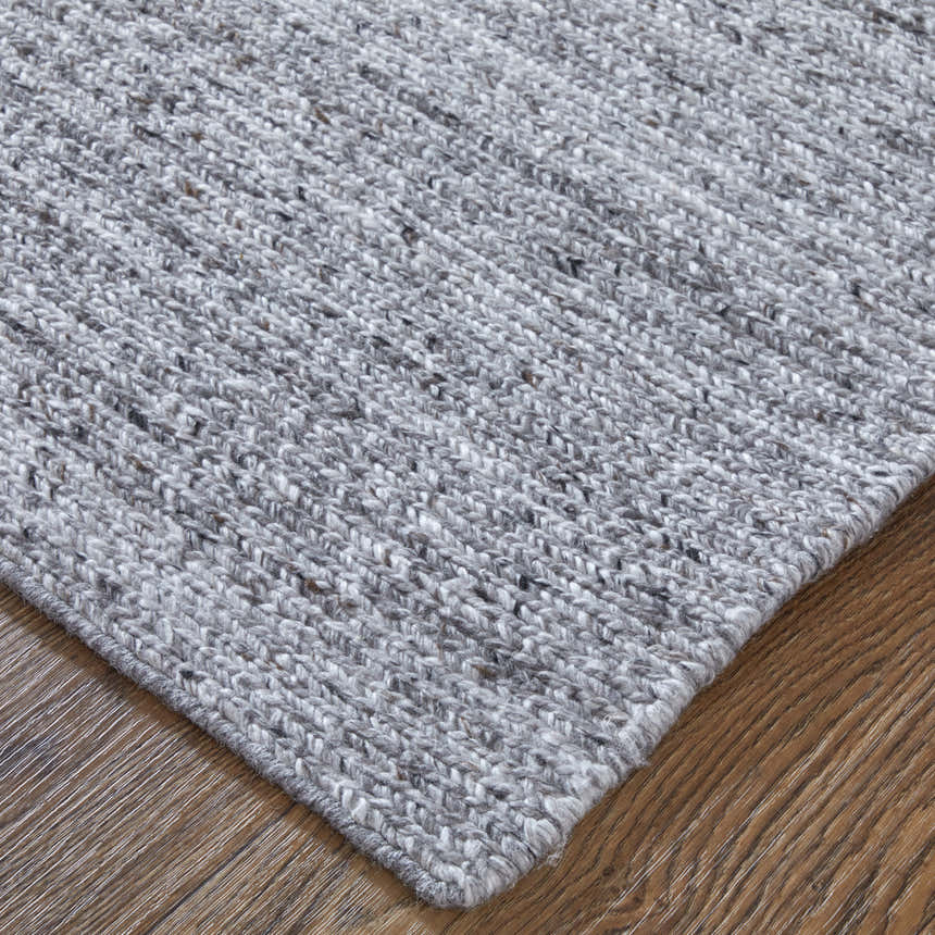 Close-up of the hand-knotted Feizy Finley Gray/Ivory area rug showing texture and color variations. Corner