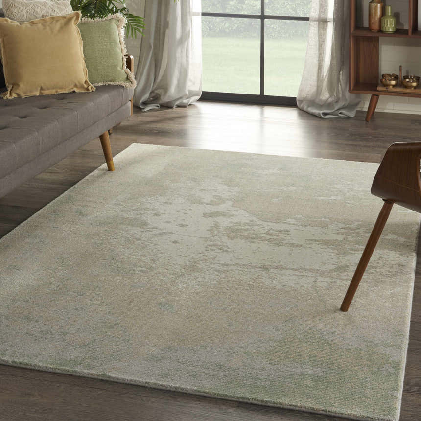 Living room with gray sofa and Nourison Twilight Ivory Green rug adding a modern, soft touch.