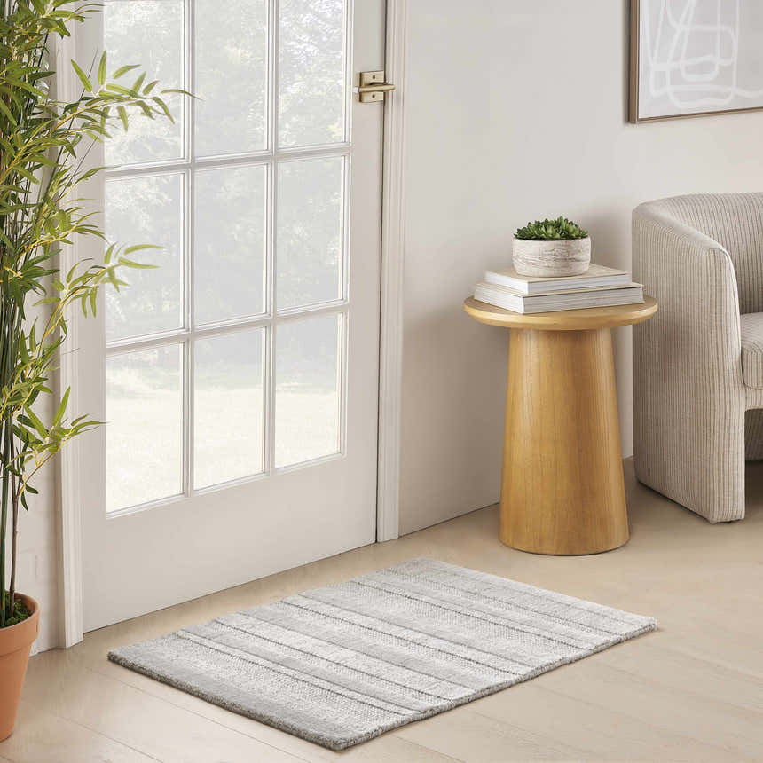 Entryway with light wood floors, white door, and DKNY Pure Multi Weave Grey Contemporary Indoor Area Rug.