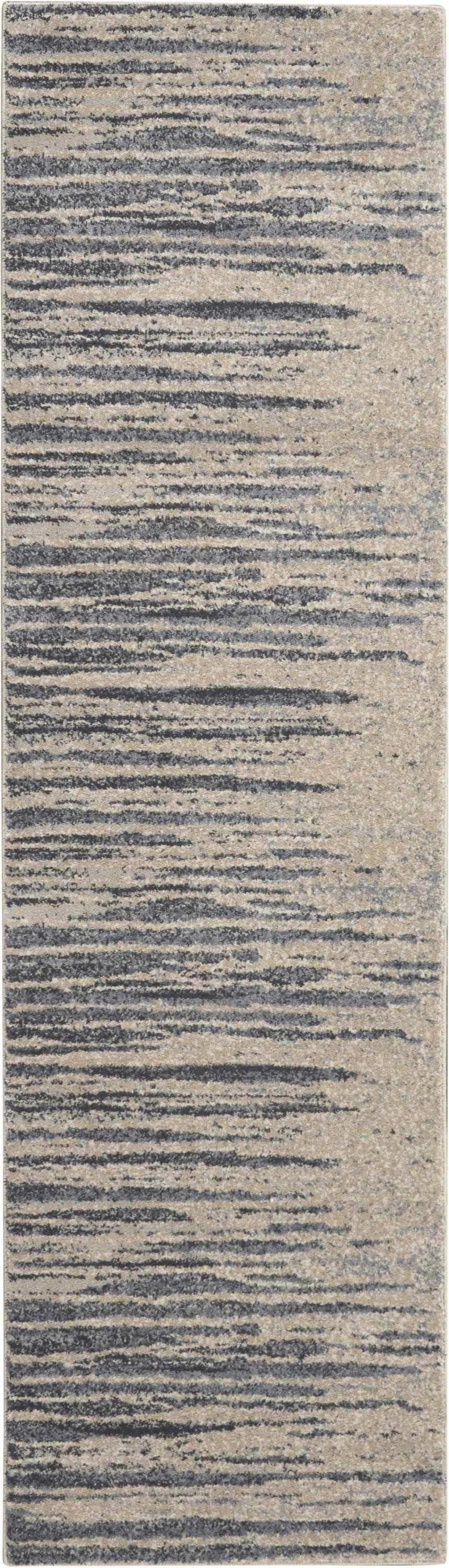Close-up of the Nourison Moroccan Celebration rug in blue and beige. Features a modern, horizontal stripe pattern.