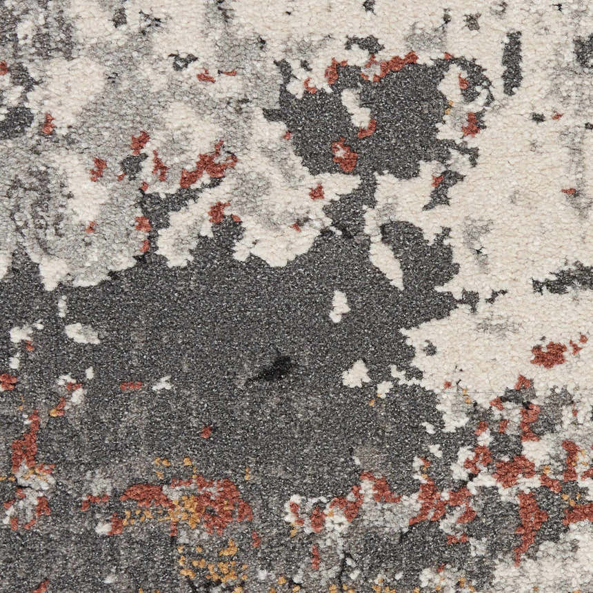 Close-up of the Nourison Tangra Grey Multicolor rug, showing its abstract pattern and textures in gray, white, and rust.