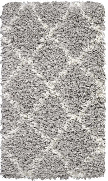 Close-up of a plush Nourison Luxe Shag rug in grey and ivory, showing the shag texture and subtle pattern.