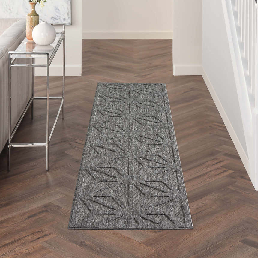 Hallway styled with Nourison Cozumel Dark Grey runner rug. Modern geometric design on wood floors.