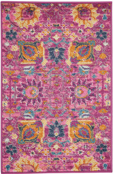 Close-up of the Nourison Passion Fuchsia rug. Features a bohemian floral pattern in fuchsia, gold, and blue.