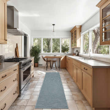 Bright kitchen with wood cabinets and Nourison Solutions Aqua Modern Washable Area Rug runner on tile floor.
