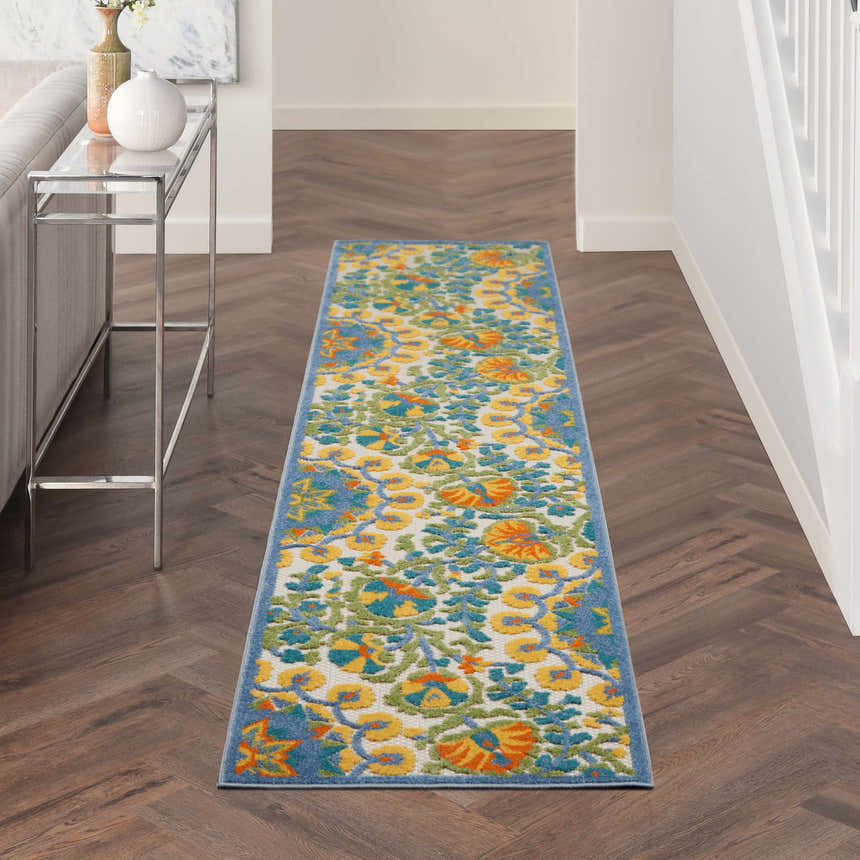 Hallway with Nourison Aloha Multicolor Transitional Area Rug runner, floral pattern, wood floors, and console table.
