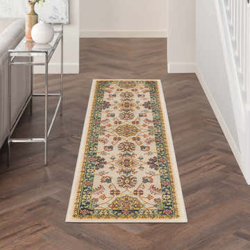 Hallway with Nourison Essentials Ivory Gold Vintage Area Rug runner on herringbone wood floor.