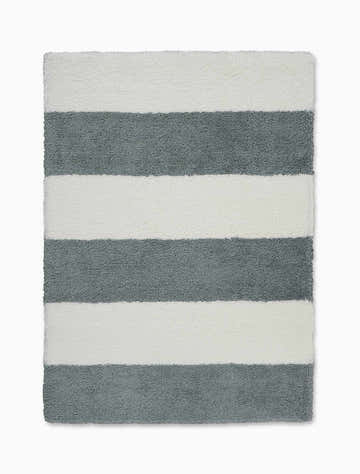 Close-up of the Calvin Klein Chicago Shag rug in white and grey stripes, a modern shag rug.