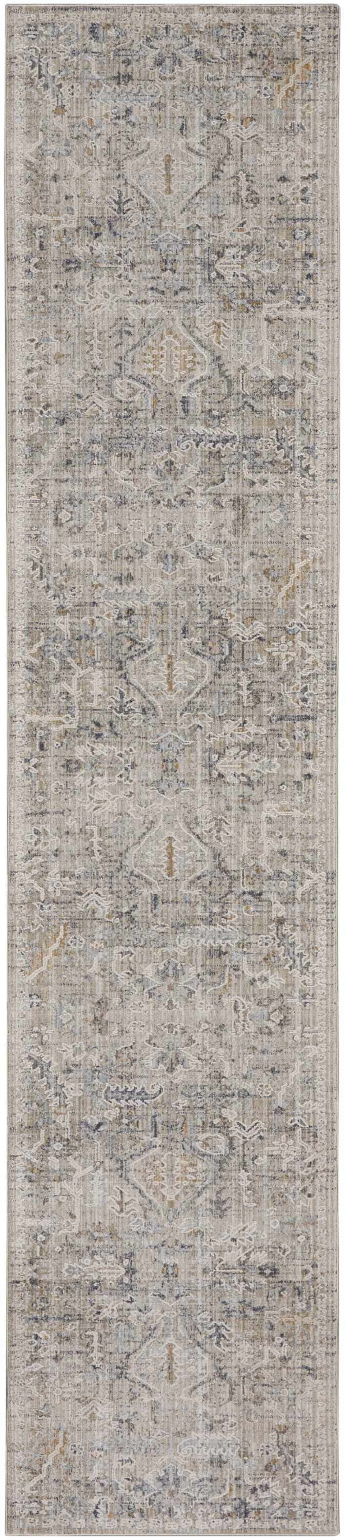 Close-up of Nourison Lynx Ivory Taupe rug. Vintage design with ivory, taupe, and blue tones. Distressed pattern and soft texture.