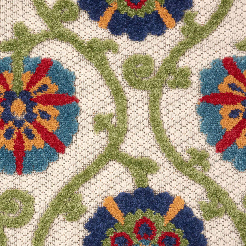 Close-up of the Nourison Aloha Blue Multicolor rug showing floral pattern in blue, red, gold, and green on a neutral background.