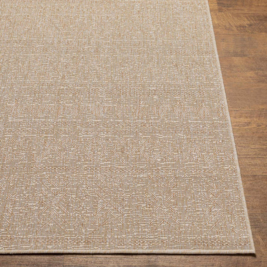 Close-up of the Vanderhoof Indoor & Outdoor Rug. Mocha and light peach tones with a subtle geometric pattern. Front