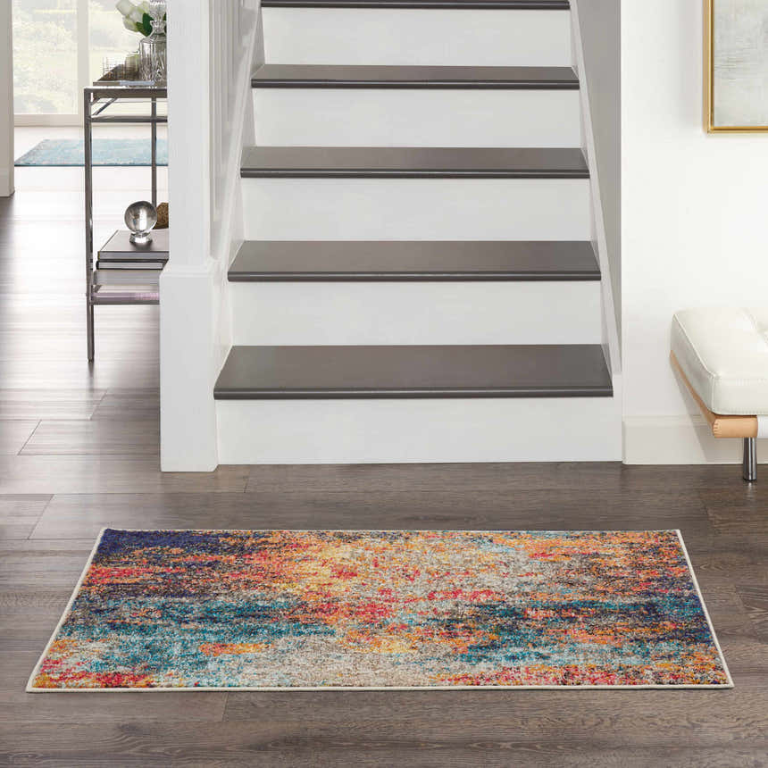 Entryway with Nourison Celestial Multicolor rug, wood floors, white stairs, and modern decor.