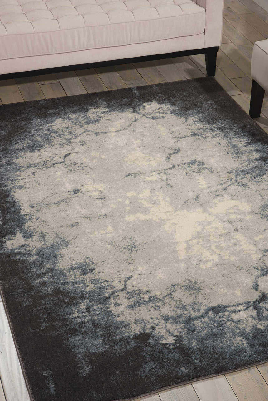 Living room scene with a Nourison Maxell Ivory Grey rug under a cream sofa on light wood floors.